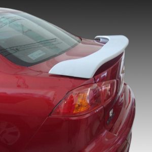 Red sports car rear quarter view showing a white aerodynamic spoiler on the trunk lid
