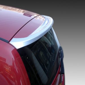 Close-up of a red car rear with a silver spoiler and curved rear window