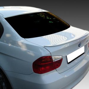 Rear quarter view of a white BMW sedan, showing the trunk and red tail lights with a blurred license plate area obscured for privacy.