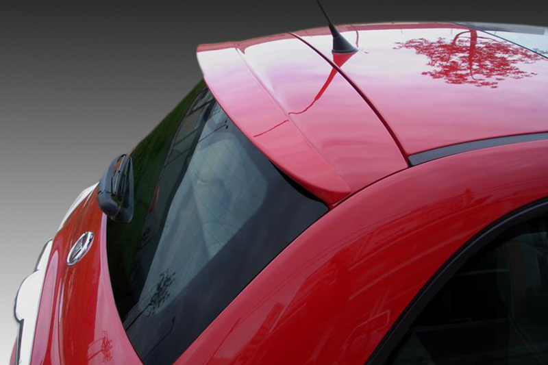 A-338_1jpg - OPSHOLDERS Close-up of a red car's rear roof and window, with a spoiler and antenna visible.