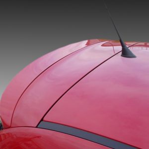 A-338_3jpg - OPSHOLDERS Close-up of a red car hood with seams and a black antenna protruding from the roof.