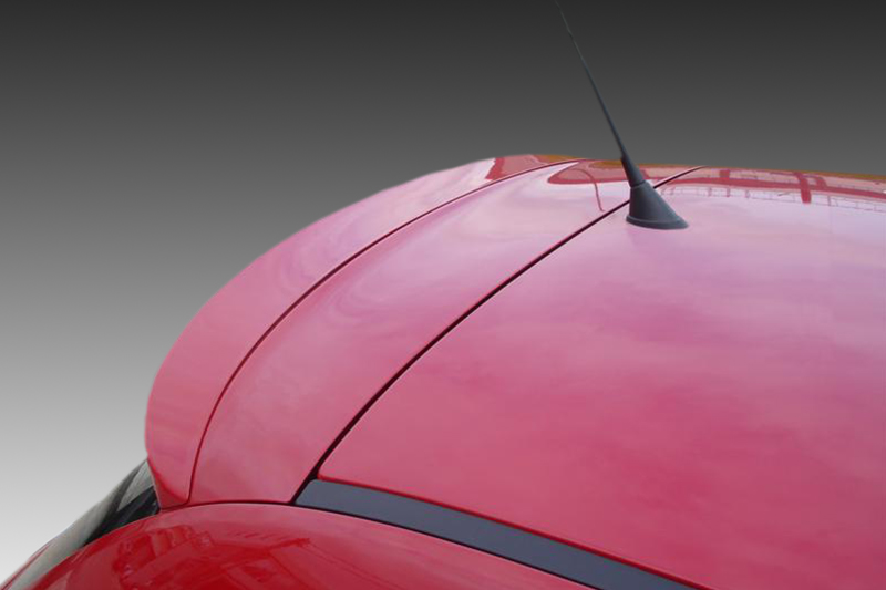 A-338_3jpg - OPSHOLDERS Close-up of a red car hood with seams and a black antenna protruding from the roof.
