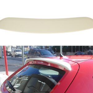 Beige curved car spoiler lip on a white background; street scene showing a red car with a rear spoiler in the foreground.