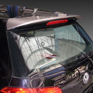 Rear view of a black Volkswagen hatchback with a curved rear window, red taillights, and chrome trim; reflections on the glass.