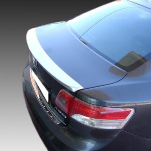 Rear view of a blue sedan with a white spoiler on the trunk and red taillights
