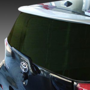 A-349_2jpg - OPSHOLDERS Rear view of a blue Toyota hatchback with dark rear window and spoiler, shown from the left rear corner.