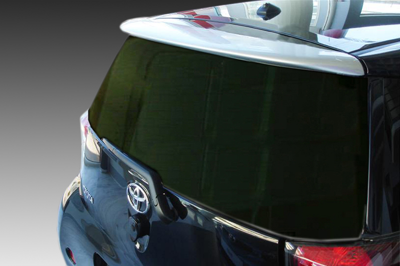 A-349_2jpg - OPSHOLDERS Rear view of a blue Toyota hatchback with dark rear window and spoiler, shown from the left rear corner.