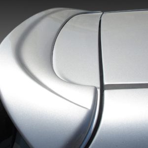 Close-up of a silver car hood showing the panel seam and curved body lines.