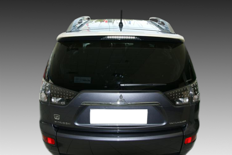 A-354_2jpg - OPSHOLDERS Rear view of a black Mitsubishi SUV (Outlander) with tinted rear window and visible badge, against a gradient backdrop.