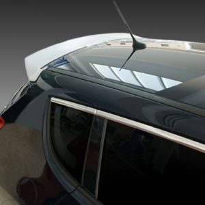 Close-up of a black car's rear showing the trunk, rear window, and red taillight with chrome trim on the edge of the window glass.