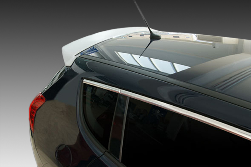 A-356_1jpg - OPSHOLDERS Close-up of a black car's rear showing the trunk, rear window, and red taillight with chrome trim on the edge of the window glass.