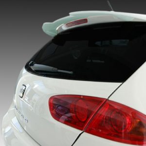 White hatchback viewed from rear-left, showing red taillights and rear window with wiper edge visible.