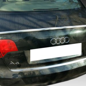 Rear view of a black Audi A4 hatchback with a blank license plate and red taillights, chrome trim on the trunk line.