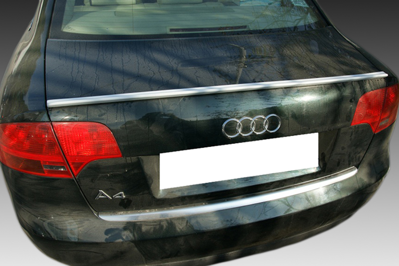 A-362_1jpg - OPSHOLDERS Rear view of a black Audi A4 hatchback with a blank license plate and red taillights, chrome trim on the trunk line.
