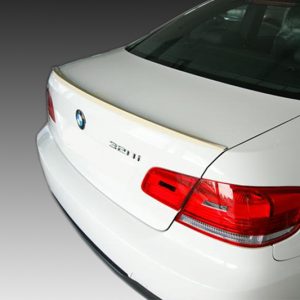 White BMW 328i sedan viewed from the rear left, showing the taillight and trunk badge.