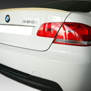 Rear view of a white BMW 320i, showing taillights, trunk, and blurred license plate with logo visible
