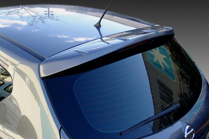 A-382_1jpg - OPSHOLDERS Rear view of a blue hatchback with a spoiler, rear window wiper, and antenna.Reflective surface shows sky and surroundings in the rear window.
