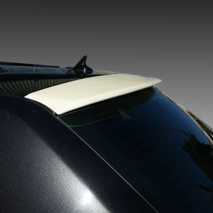 Rear of a black car showing a white spoiler on the hatch and a curved tinted rear window.