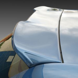 Close-up of a blue car's hood and chrome trim, showing reflections and metal contours near the windshield edge.
