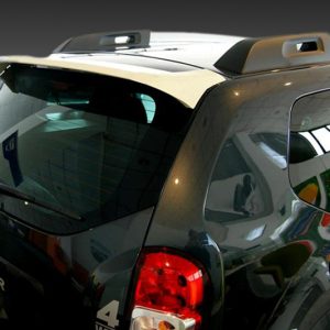Rear view of a dark SUV (Duster) with roof rails, showing the back window and wiper in a showroom-like setting.