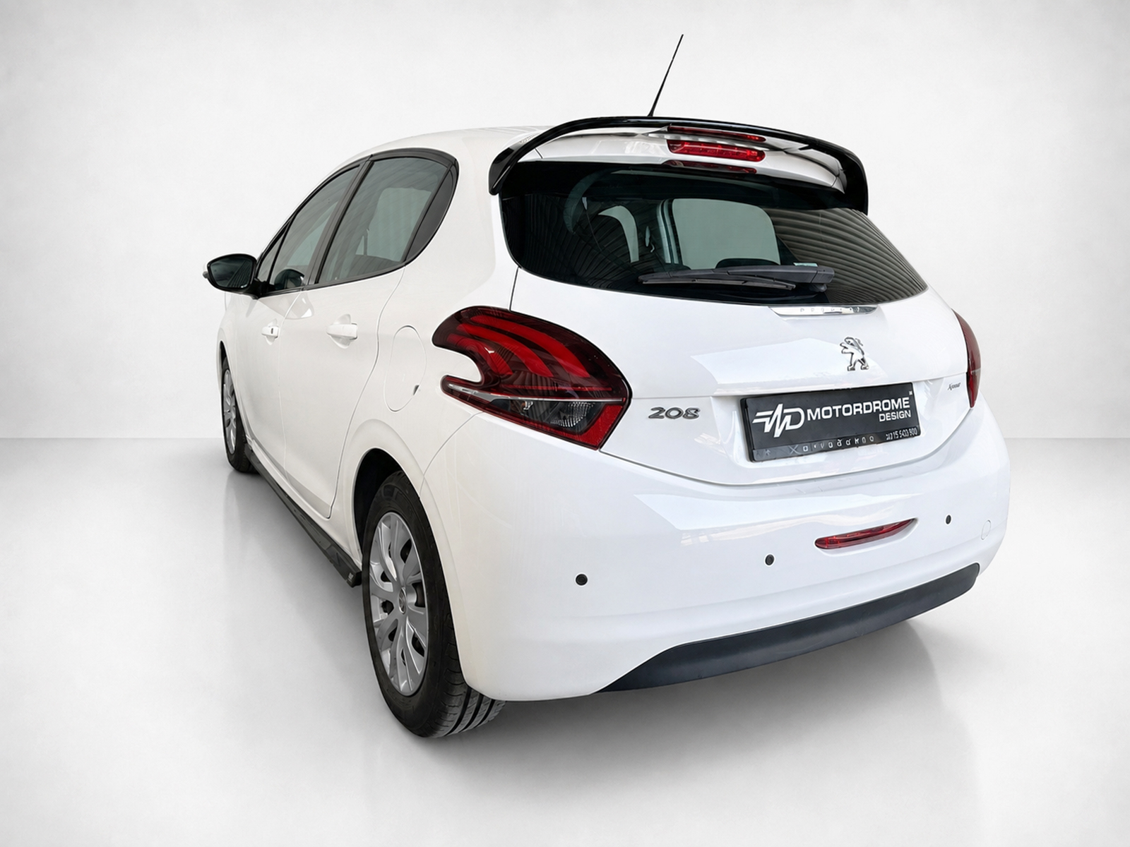A-397_2jpg - OPSHOLDERS White Peugeot 208 hatchback photographed from the rear-left, showing distinctive red taillights and rear spoiler.