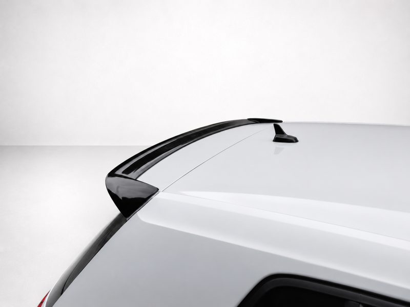 A-403_3jpg - OPSHOLDERS Rear roofline of a white SUV with a black roof spoiler and shark-fin antenna against a light background.