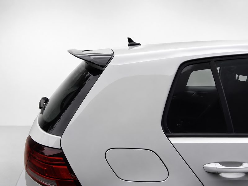 A-403_6jpg - OPSHOLDERS Rear quarter of a silver SUV showing taillight, rear window, and roof spoiler/antenna on top.