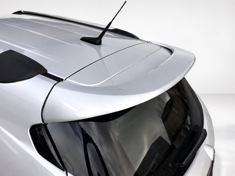 A-409_3jpg - OPSHOLDERS Close-up of a silver car roof showing a rear spoiler and roof antenna with a glossy finish.