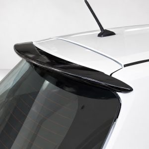 Close-up of a white car's rear roof showing an integrated spoiler and rear window with defroster lines.