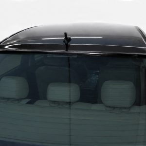 Car front windshield with a roof antenna, beige headrests visible through the glass.