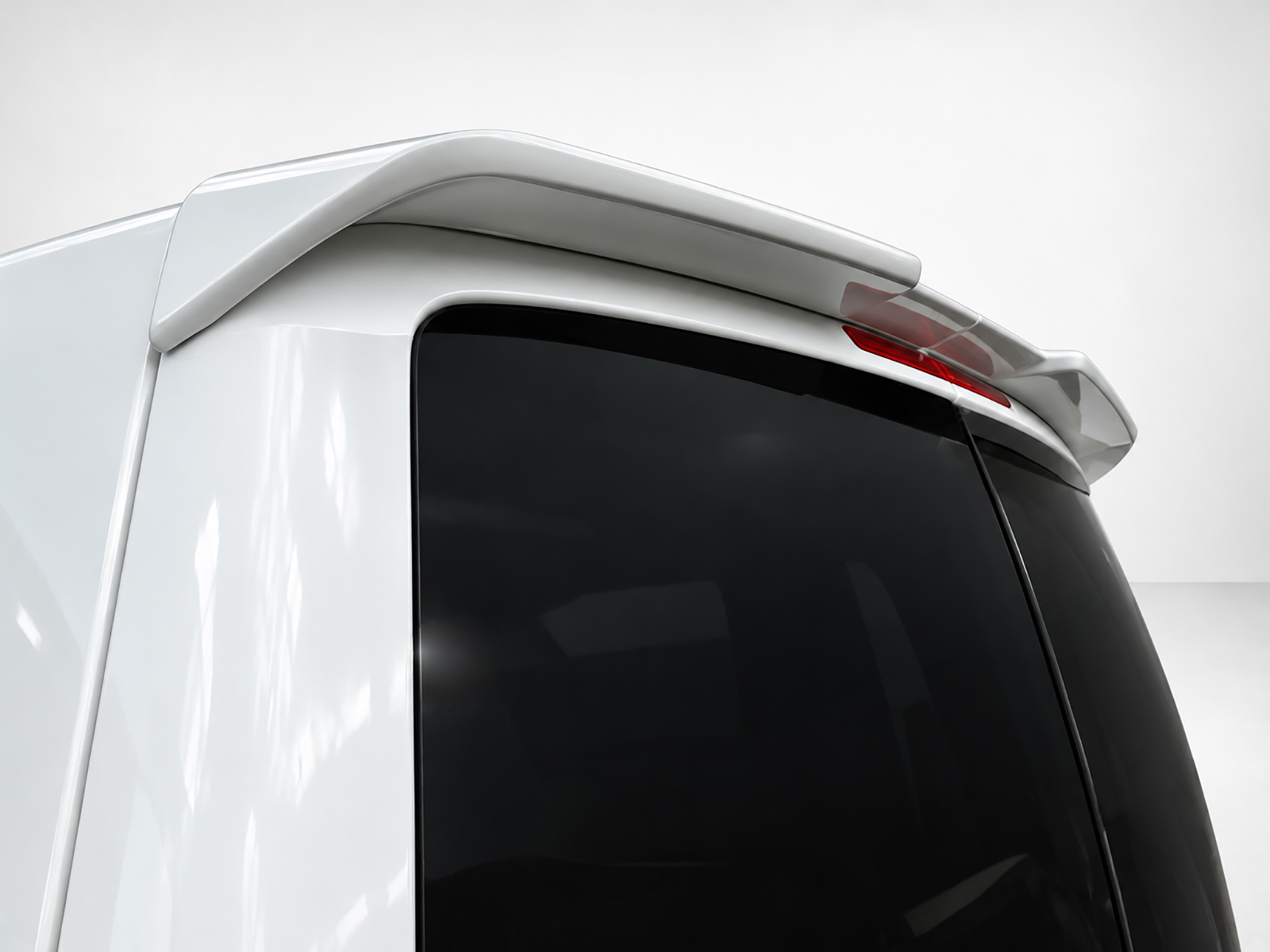 A-418_1-1jpg - OPSHOLDERS Close-up of a white vehicle's roof-mounted spoiler above the rear window.