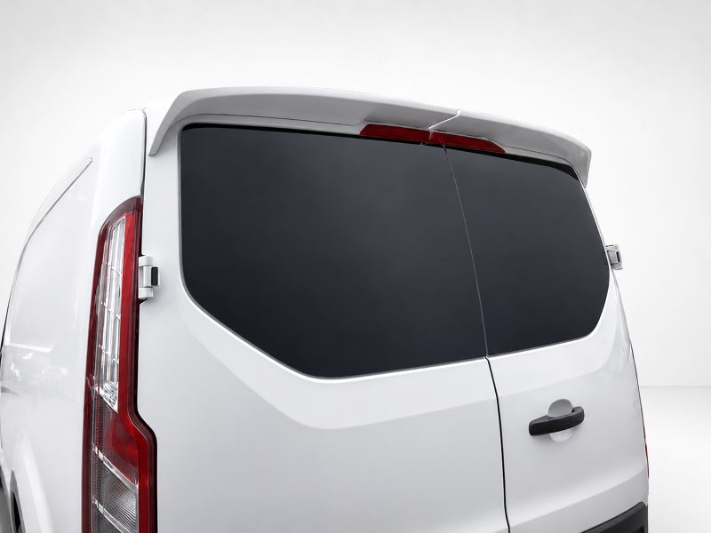 Rear view of a white van with dark-tinted rear windows and red taillights on the left side of the image
