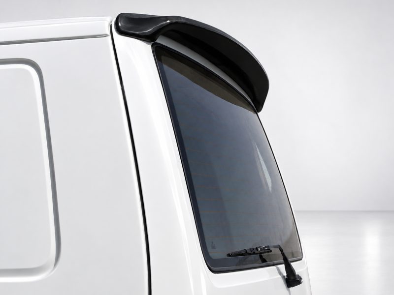 A-421_4jpg - OPSHOLDERS White vehicle rear window with a black spoiler above and a rear wiper at the bottom of the window