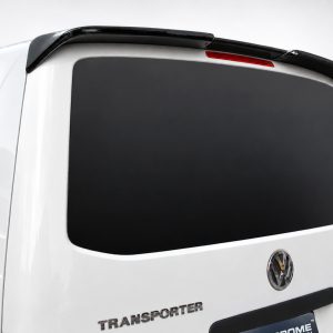 White VW Transporter van rear with darktinted rear window and black roof spoiler/wing, VW badge visible
