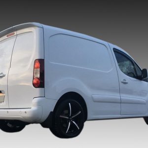 White cargo van photographed from the rear-right, showing closed doors and black alloy wheels on a gray gradient background.