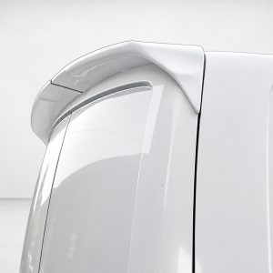 White car rear spoiler attached to the trunk lid, showcasing an aerodynamic design and seamless integration with the vehicle.