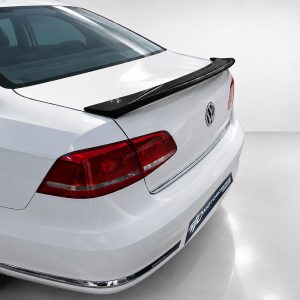 A-432_3jpg - OPSHOLDERS Rear view of a white Volkswagen sedan, featuring a black spoiler and red tail lights in a studio setting.