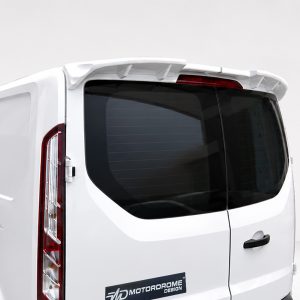 White van rear with tinted window, vertical taillight, and a roof spoiler; logo reads 'MotorDrome Design' on the bumper area.