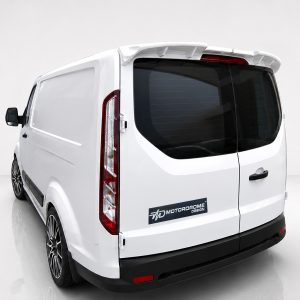 Rear three-quarter view of a white cargo van with dark rear window and red taillights; MOTORDOME DESIGN badge on the back door.