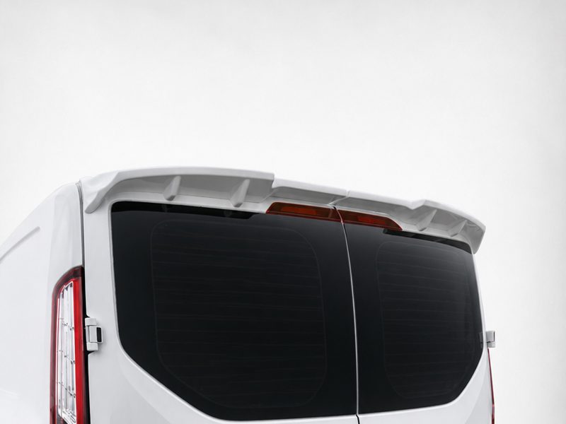 Rear view of a white van showing a roof spoiler above the rear windows and brake lights across the back.