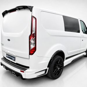A-434_2jpg - OPSHOLDERS Rear three-quarter view of a white cargo van with black wheels and tinted side window in a studio setting.