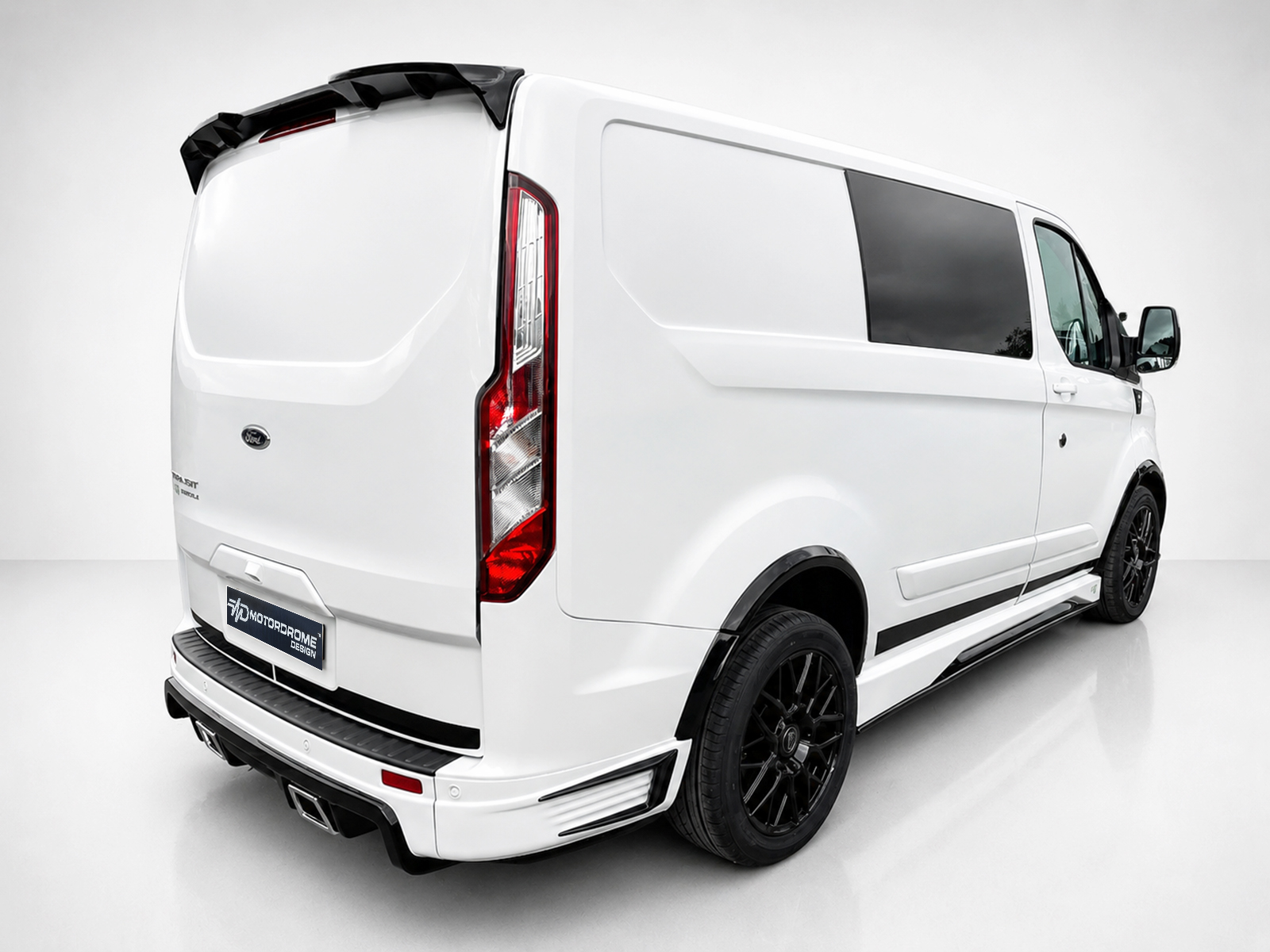 A-434_2jpg - OPSHOLDERS Rear three-quarter view of a white cargo van with black wheels and tinted side window in a studio setting.