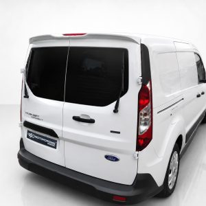 Rear-left view of a white Ford Transit cargo van in a bright studio setting.
