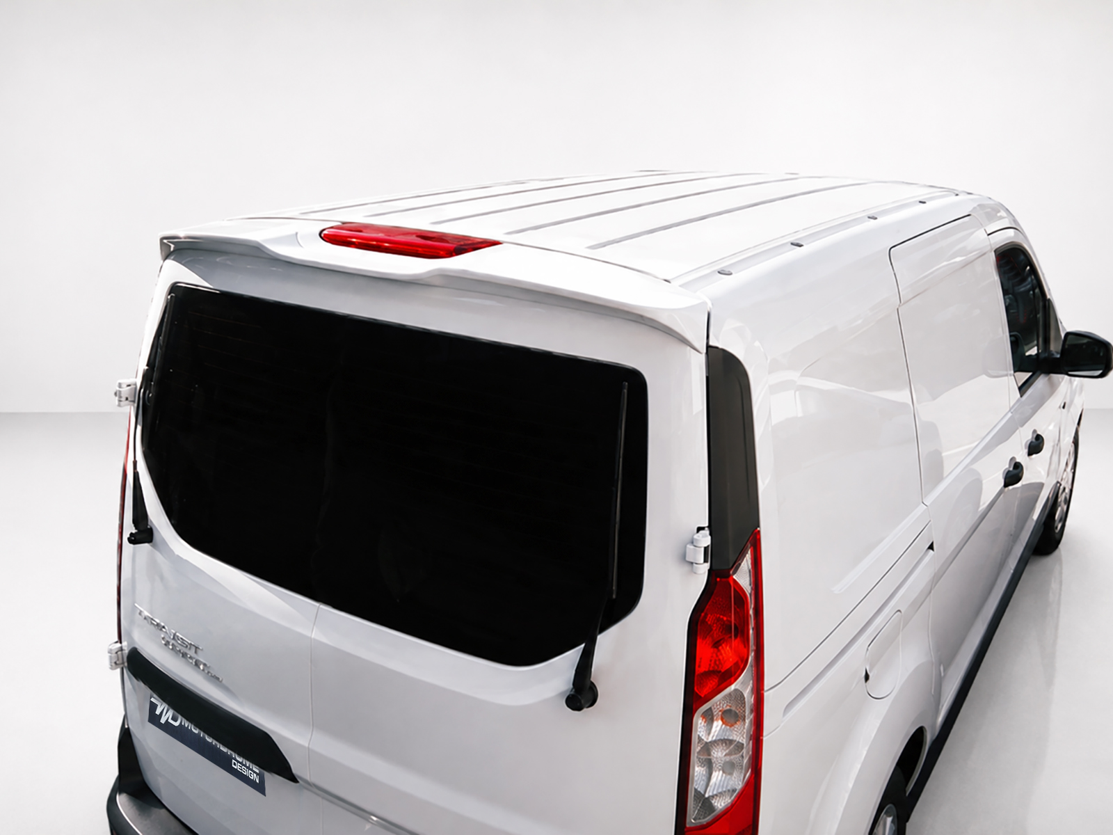 A-441_2jpg - OPSHOLDERS Rear-left view of a white cargo van, showing the rear doors, dark rear window, and tail lights in a studio setting.