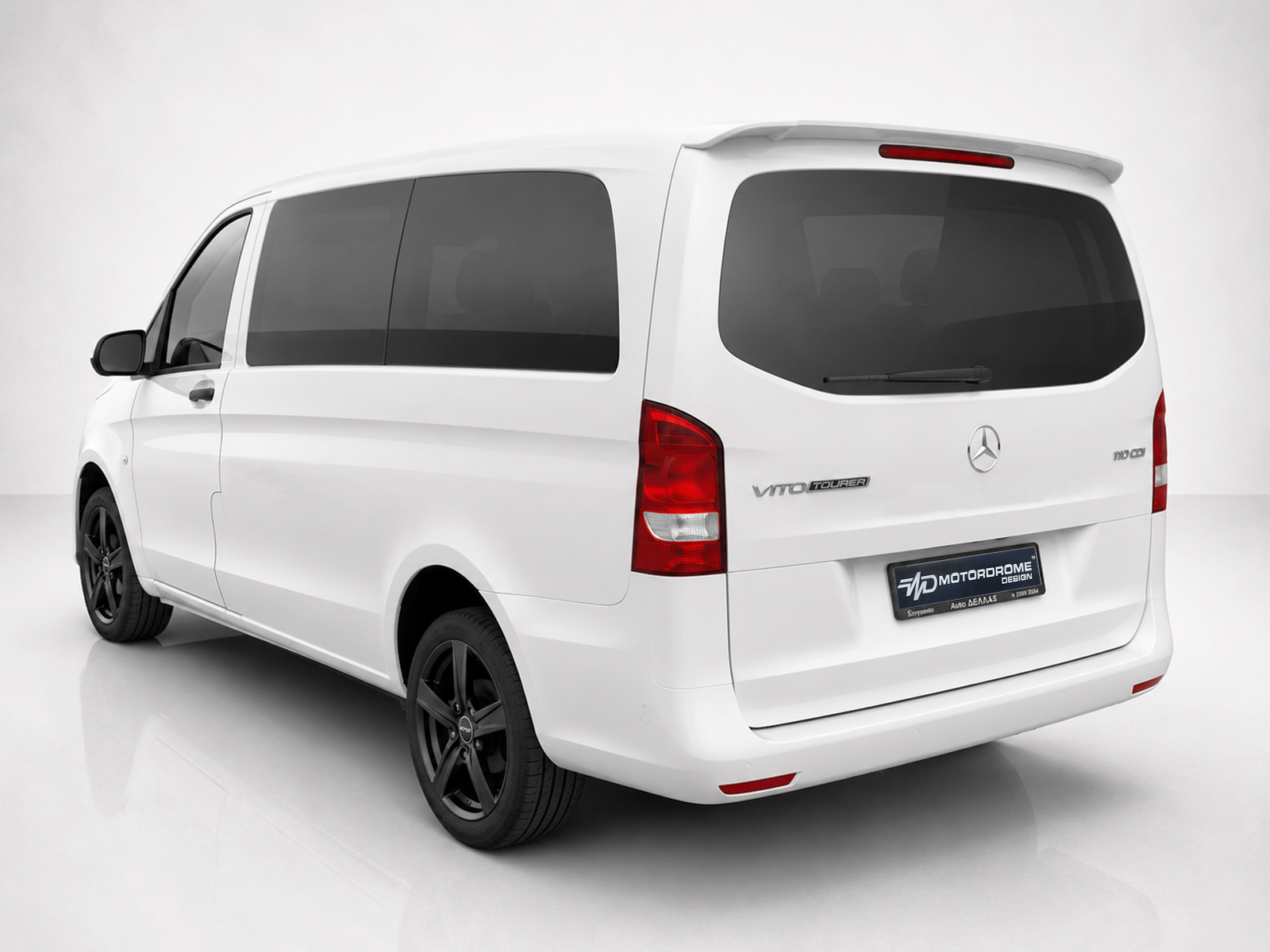 A-442_2jpg - OPSHOLDERS Rear and left-side view of a white Mercedes Vito Tourer van with dark windows and black wheels indoors.