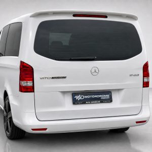 A-442_3jpg - OPSHOLDERS Rear view of a white Mercedes Vito Tourer van with tinted rear window, wiper, and red taillights on a studio floor.