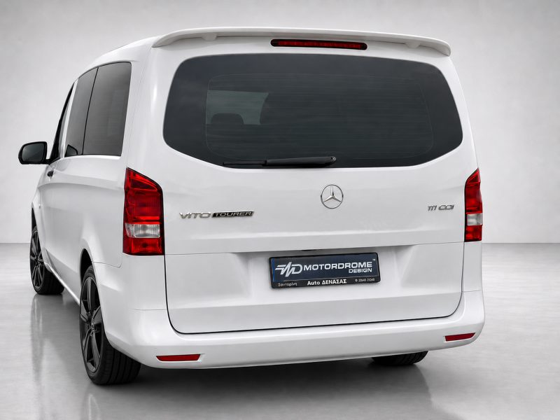 A-442_3jpg - OPSHOLDERS Rear view of a white Mercedes Vito Tourer van with tinted rear window, wiper, and red taillights on a studio floor.