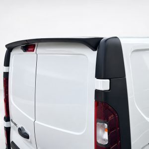 Rear-right view of a white cargo van with split rear doors, red taillights, and black bumper guards/sill trim.