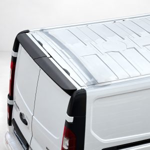 Rear-right view of a white cargo van with a metal-toned roof rack and black trim details behind the rear door.
