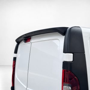 Rear quarter view of a white van with a black roof spoiler and red taillights visible.|